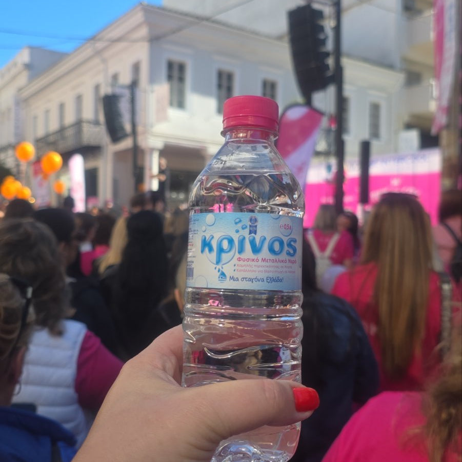KRINOS Natural Mineral Water bottle with a pink cap at Pink the City 2026 in Patras.
